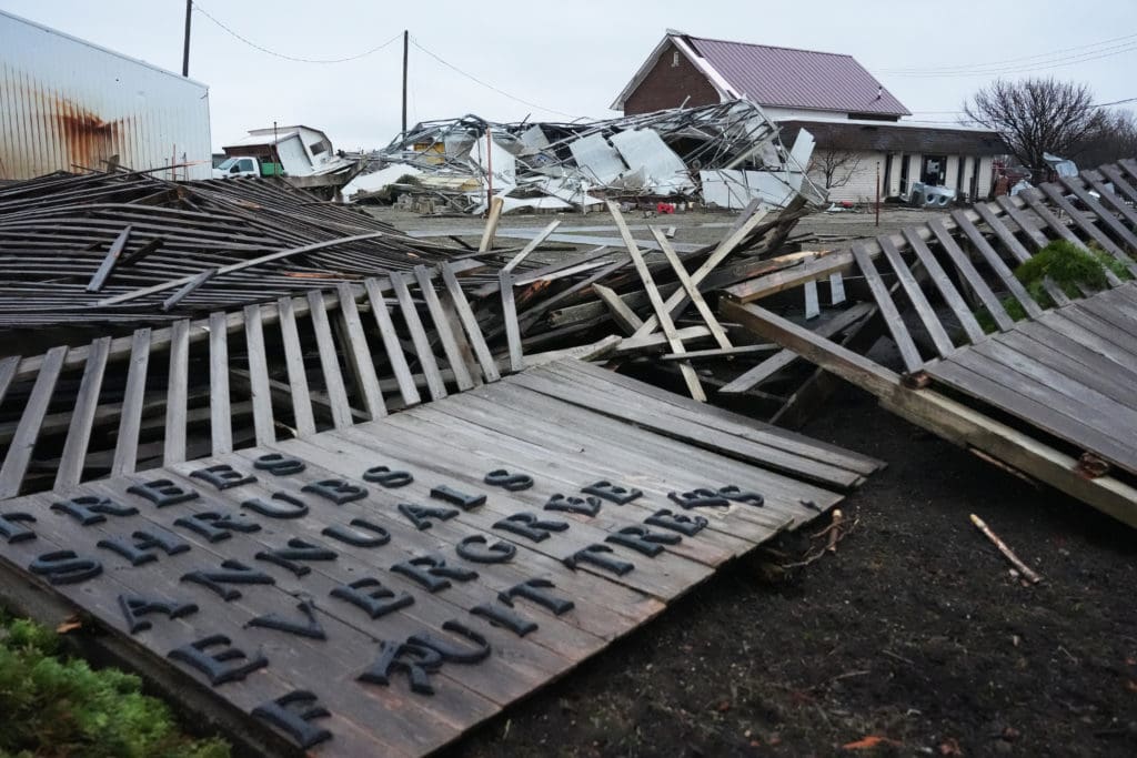 Damage to a garden center sign and building after a severe storm.