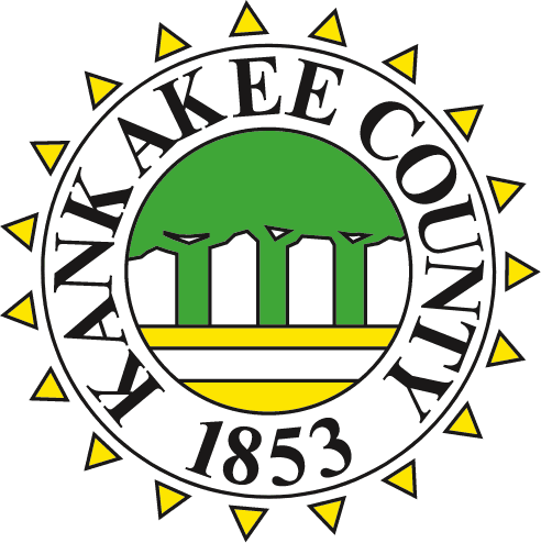 Kankakee County seal featuring three bridge arches and the year 1853, surrounded by yellow sun icons.