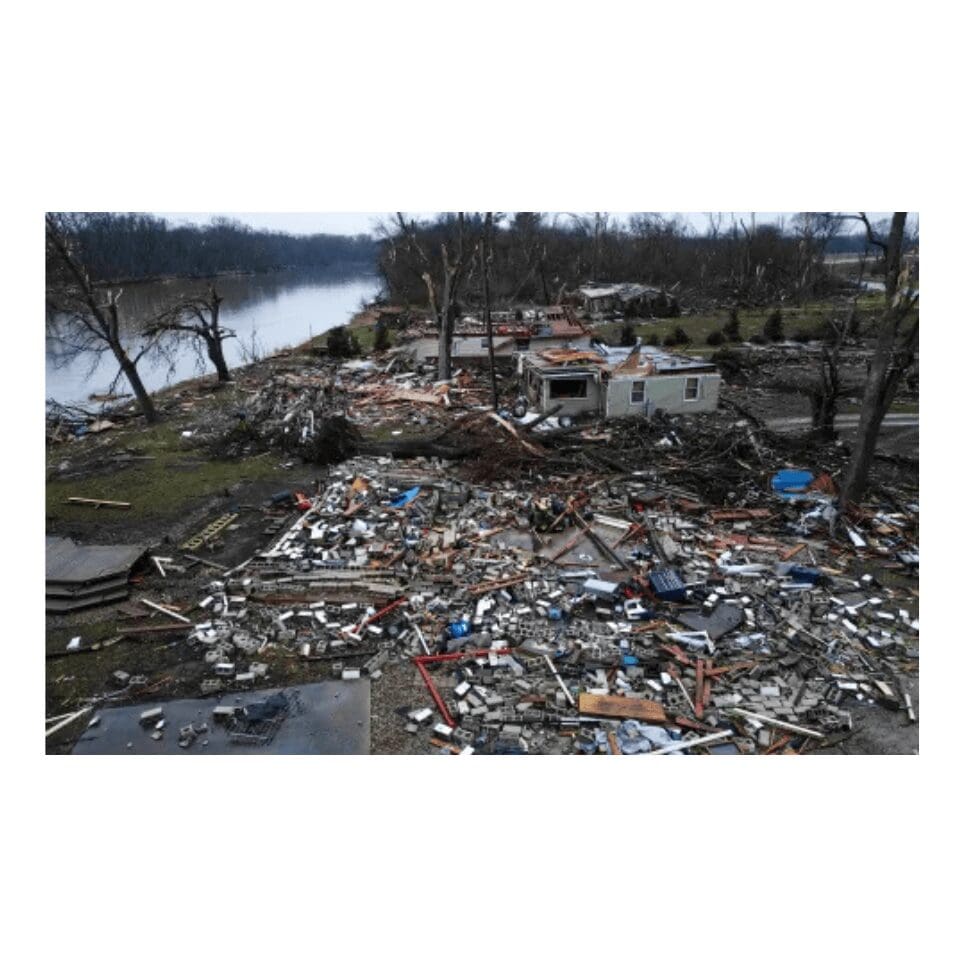 Tornado aftermath showing debris and damage near a riverbank.